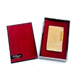 A gold plated lighter by S. T. Dupont, 5.8cm high, in original box