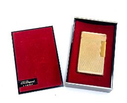 A gold plated lighter by S. T. Dupont, 5.8cm high, in original box
