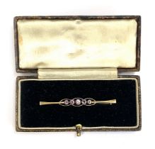 A 9ct gold Edwardian bar brooch set with five amethysts in milgrain settings, 5cmL, 1.9g, in box