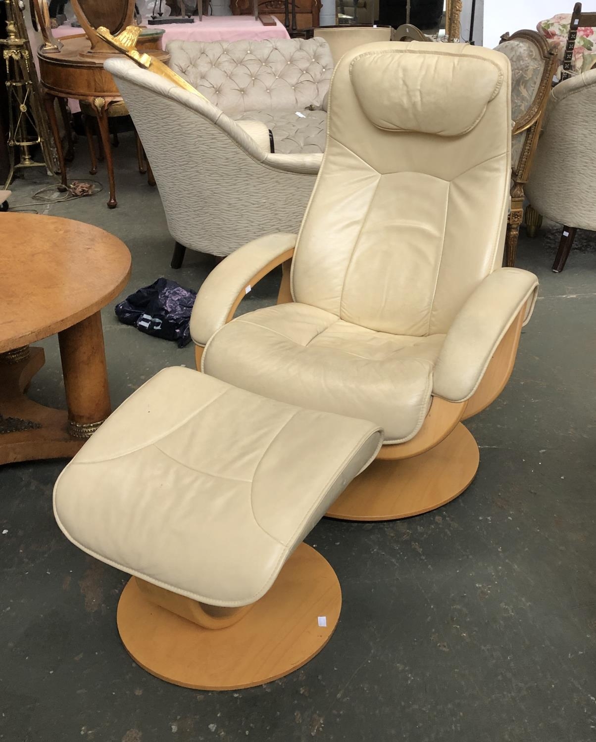A Norwegian leather and bent plywood reclining swivel chair in a pale cream colourway '