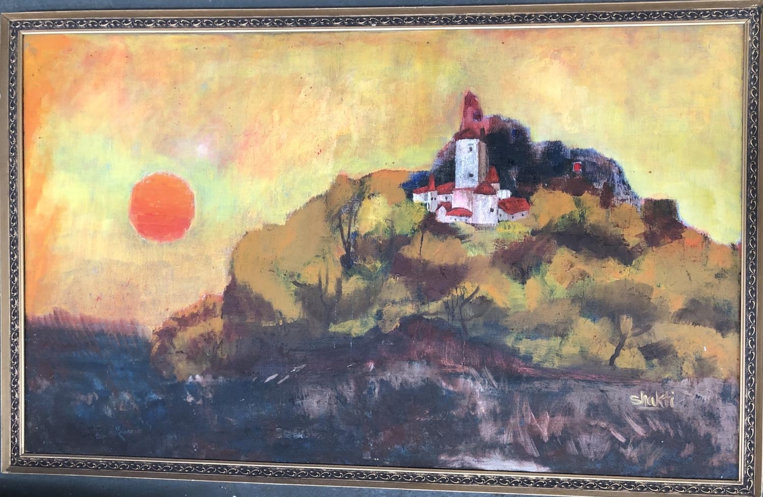 A 20th century oil on canvas depicting a hilltop village at sunset, signed Shakti, 76x126cm