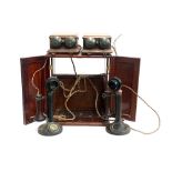 Two 1920s bakelite candlestick telephones, model no. 150, PL 124 No.22, each with bell boxes, in