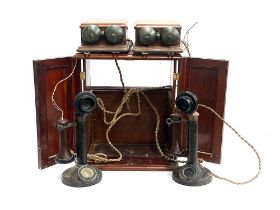 Two 1920s bakelite candlestick telephones, model no. 150, PL 124 No.22, each with bell boxes, in