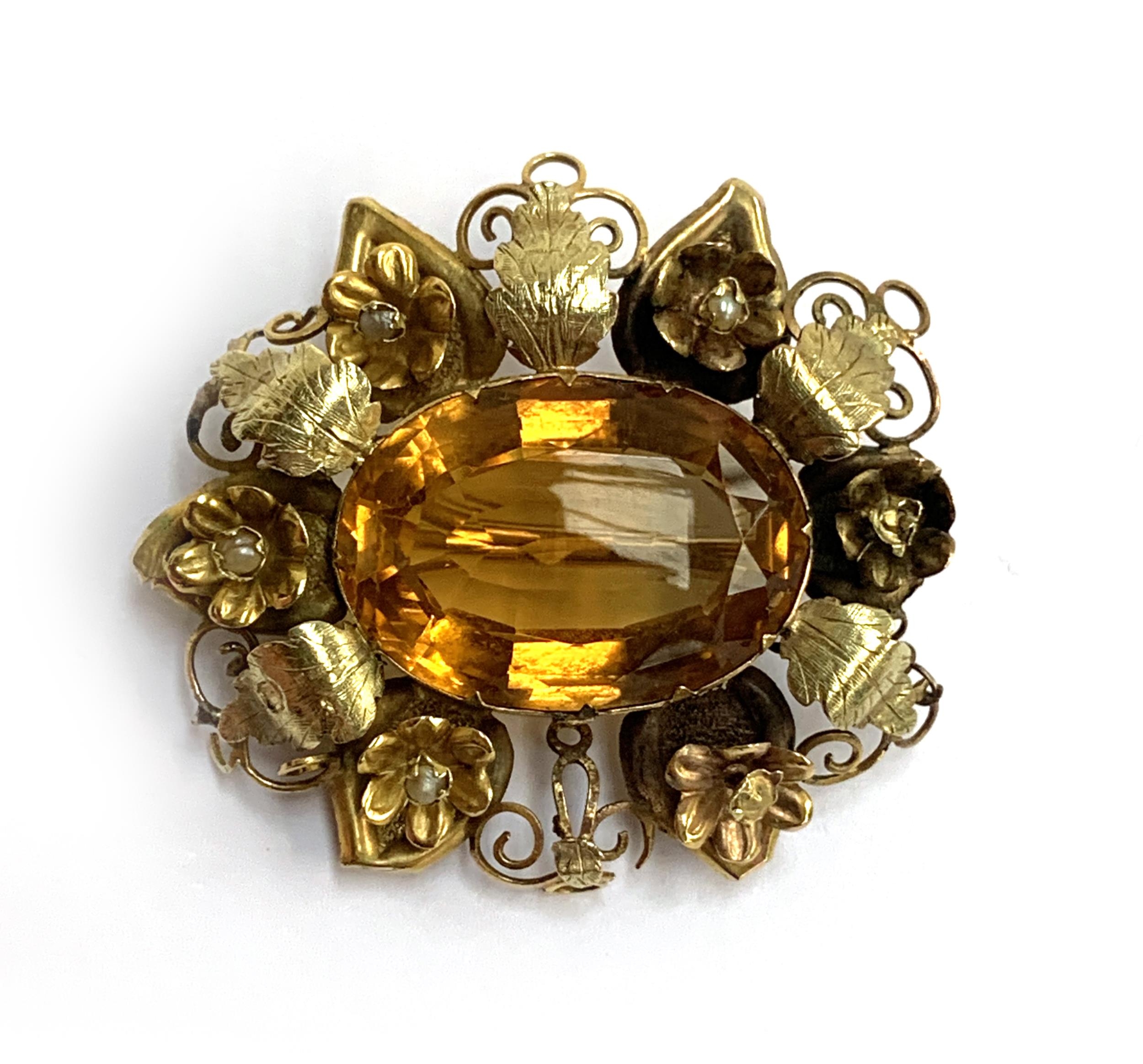 A two coloured gold brooch set with a central citrine surrounded by leaves and flowers (af), 3.7cmL,