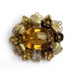 A two coloured gold brooch set with a central citrine surrounded by leaves and flowers (af), 3.7cmL,