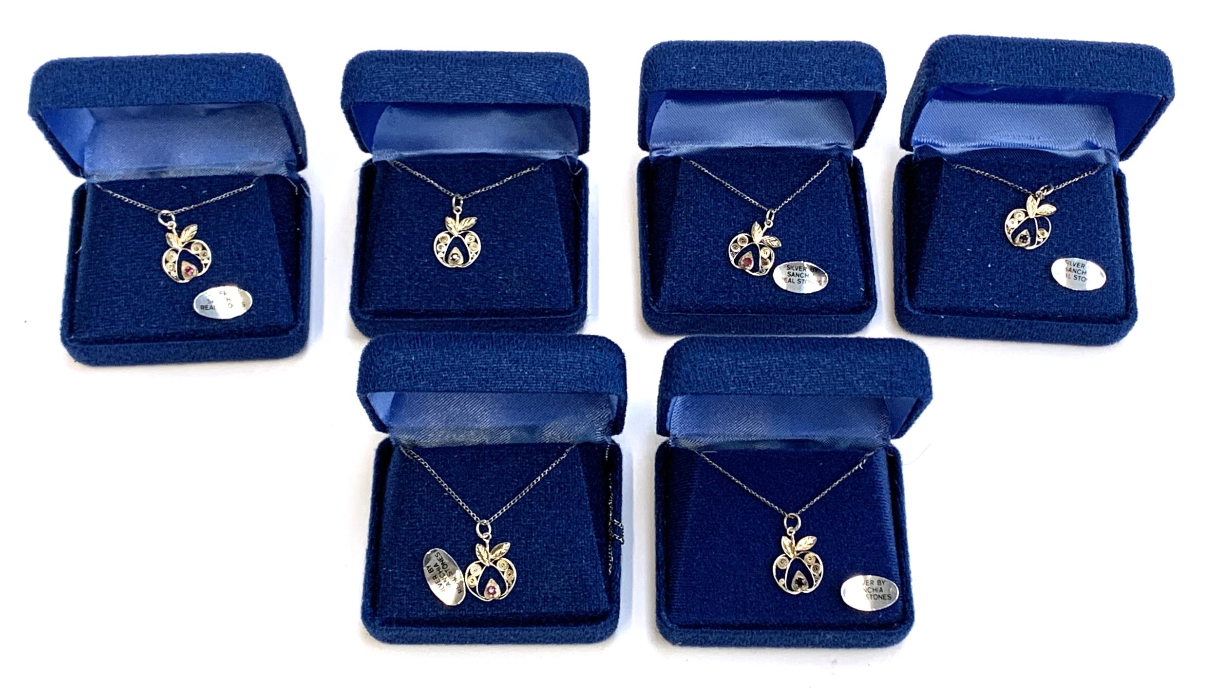 Six boxed 'Sanchia' silver apple pendants on chains, set with rubies and sapphires, the pendants 1.