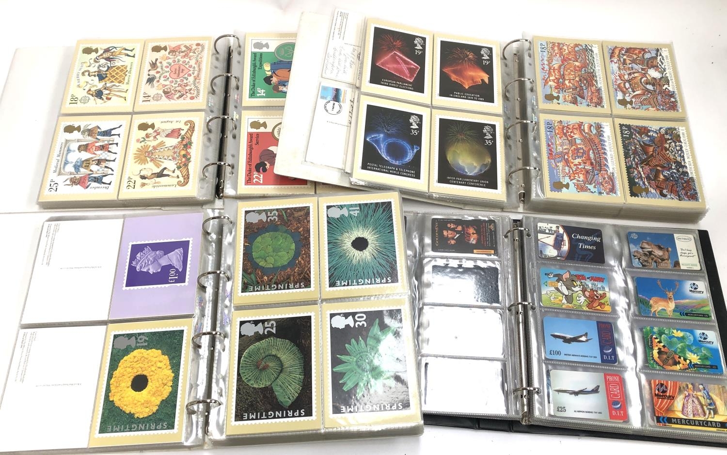 A large quantity of PHQ cards in three albums, together with an album of phonecards