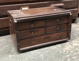 An oak cabinet of five drawers, containing a quantity of engineers tools, mostly drillbits and die