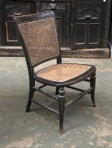 A 19th century ebonised and caned bedroom chair