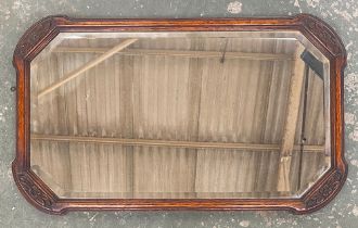 A rectangular wall mirror in carved oak frame, bevelled glass with canted corners, 75x46cm