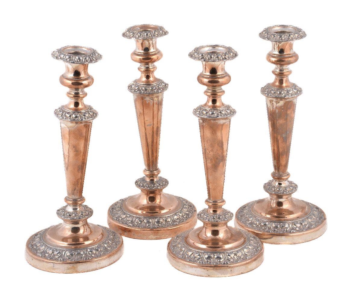 A set of four old Sheffield plate circular candlesticks, circa 1830, 28cm (11in) high