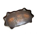 A Newlyn school copper tray with wavy edge, engraved with a fish, 38x23cm