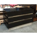 A modern black stained chest of three drawers, 140x60x80cmH