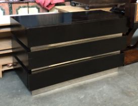 A modern black stained chest of three drawers, 140x60x80cmH