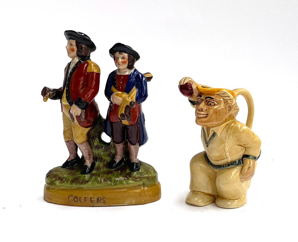 A Staffordshire 'Golfers' figurine, 24cmH; together with a cricketer jug (2)