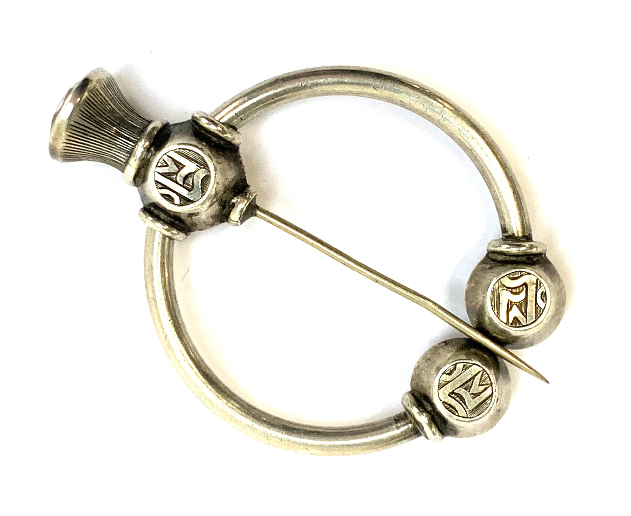 A Victorian silver Scottish penannular brooch set with foiled stones, with a thistle shaped pin - Image 2 of 3