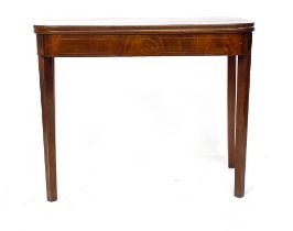 A George III mahogany and line inlaid tea table, foldover top raised on square tapered legs,