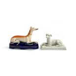 A Staffordshire pen holder of a recumbent greyhound, 15.5cmL, together with one other, 13.5cmL (2)