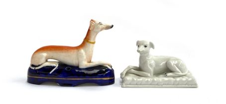 A Staffordshire pen holder of a recumbent greyhound, 15.5cmL, together with one other, 13.5cmL (2)