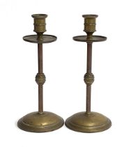 A pair of 19th century brass and copper candlesticks with knopped stems, 20.5cmH