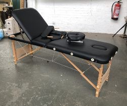 A massage/beauty table with back rest and travel case