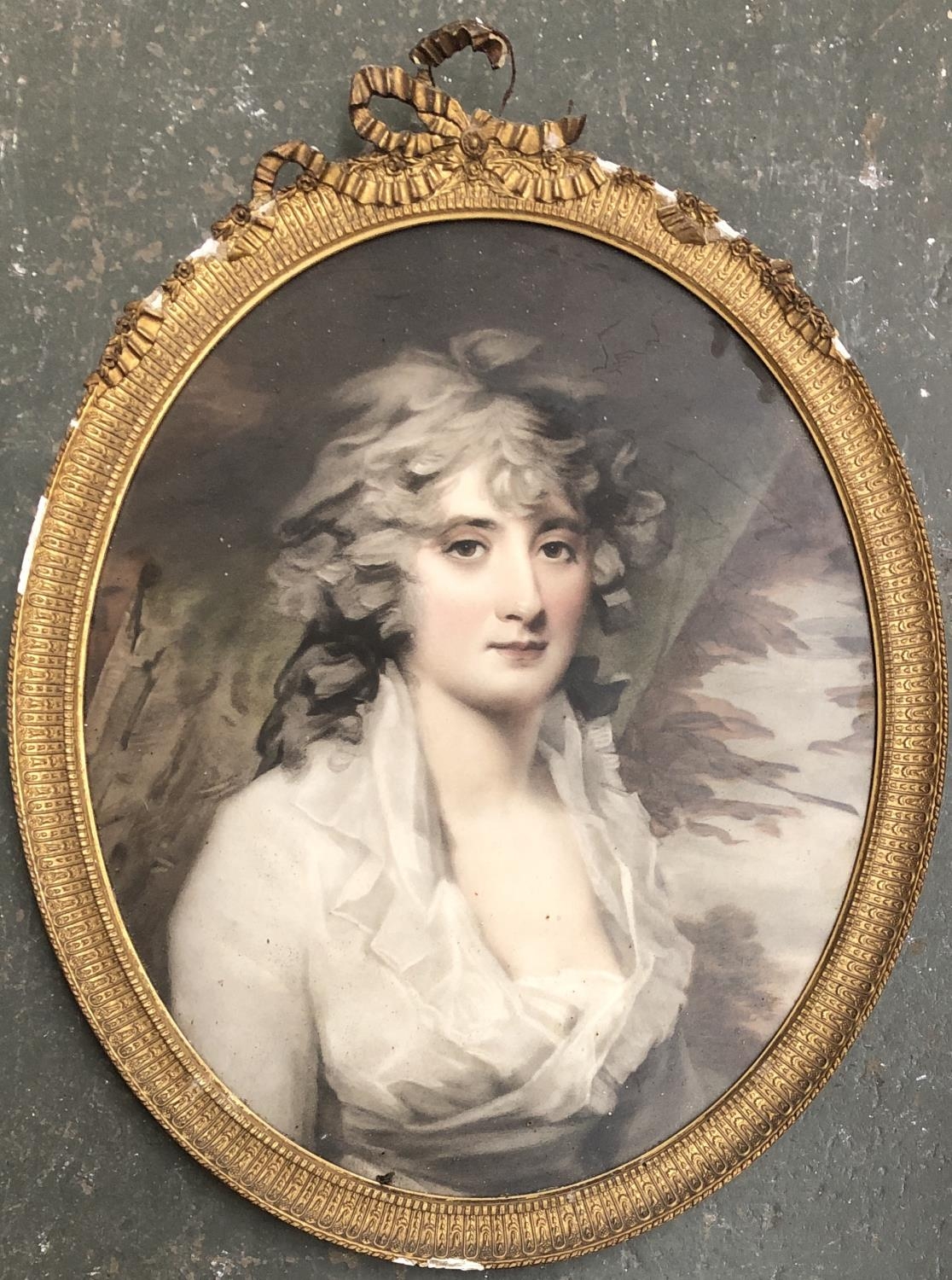 A late 18th century colour mezzotint portrait of a lady, in a gilt gesso oval frame with ribbon