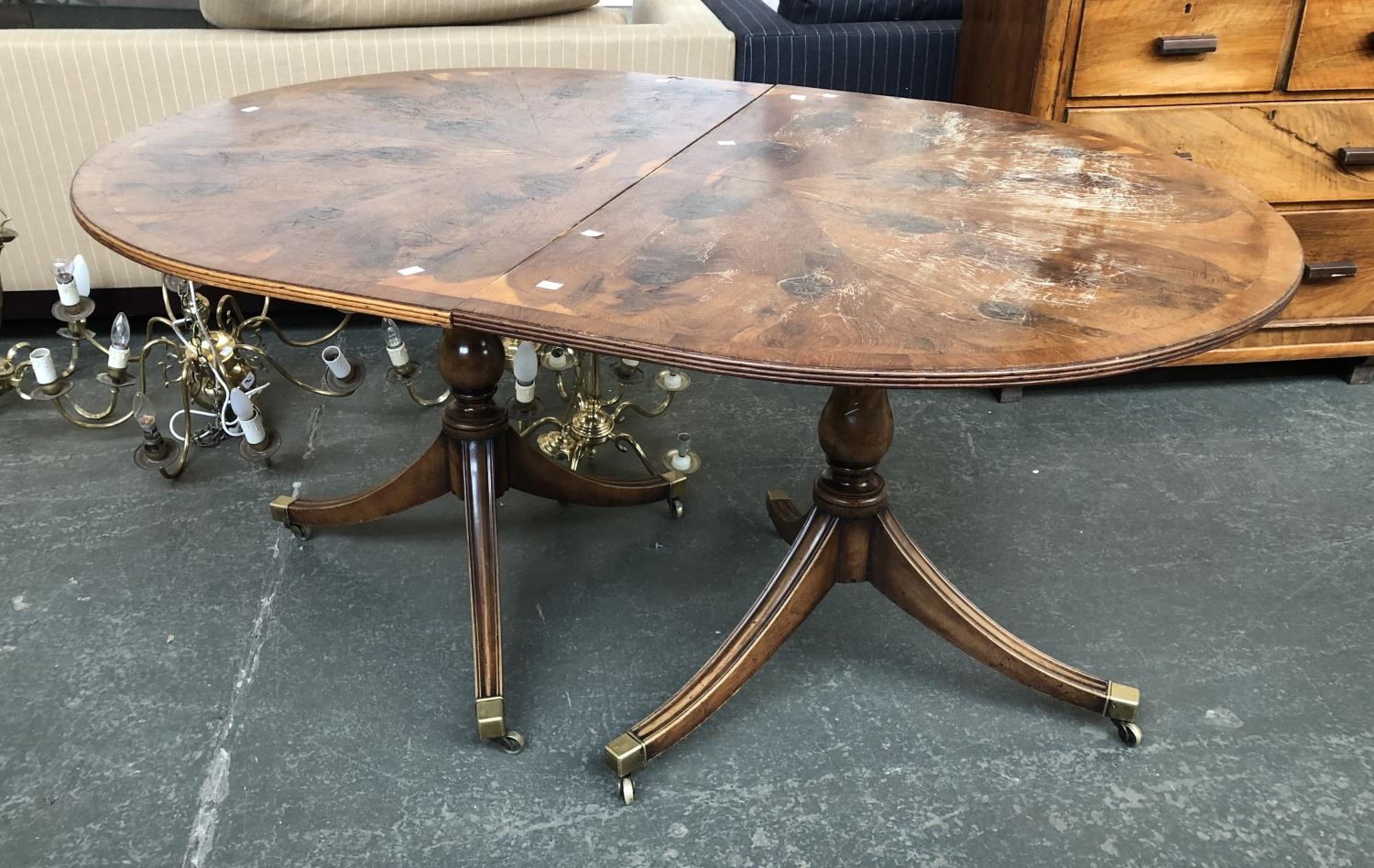 A Regency style D end dining table with radial yew veneer, on twin baluster columns and swept