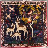 A small wool rug depicting deer beneath a tree, approx. 67x70cm