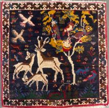 A small wool rug depicting deer beneath a tree, approx. 67x70cm