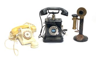 Three vintage telephones: A 1950s ivory coloured French rotary dial, a candlestick telephone, and