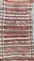 A small striped Moroccan rug, 109x64cm