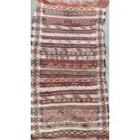 A small striped Moroccan rug, 109x64cm