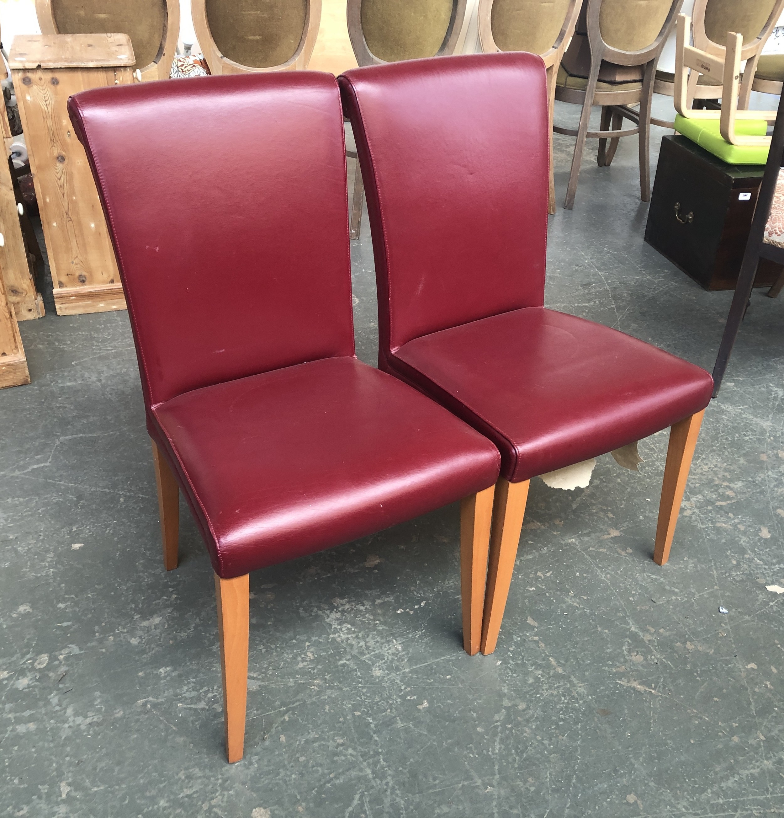 A pair of Poltrona Frau 'Vittoria' claret leather upholstered side chairs, on beechwood frames,