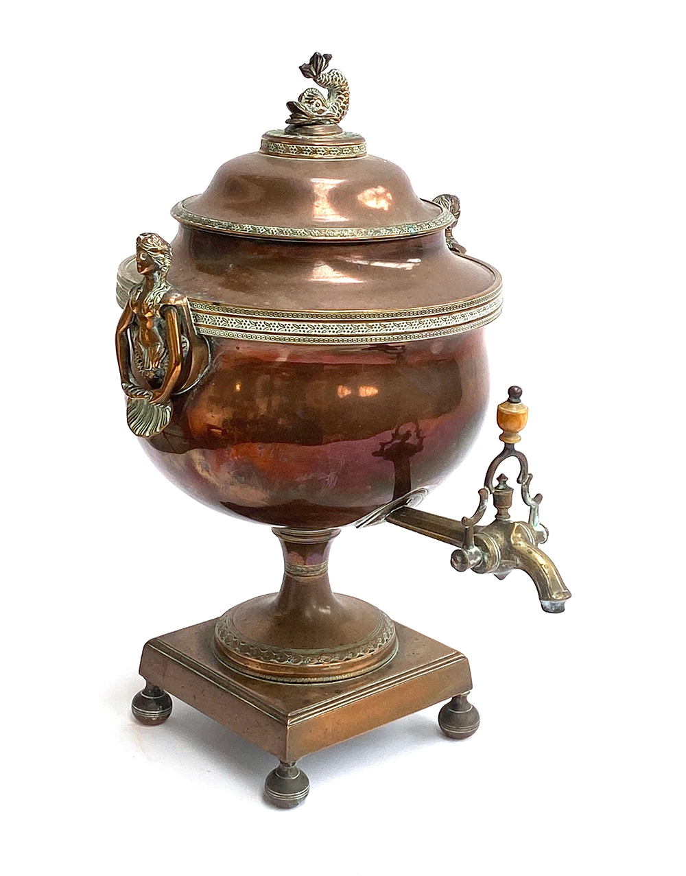 A 19th century copper and brass samovar with dolphin finial and mermaid handles, 37cmH