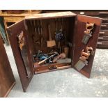 A teak carpenters cabinet, fitted interior, hung with various tools, to include Marples chisels,
