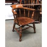 A 19th century ash and elm smokers bow armchair, on heavily turned legs and double H stretcher,