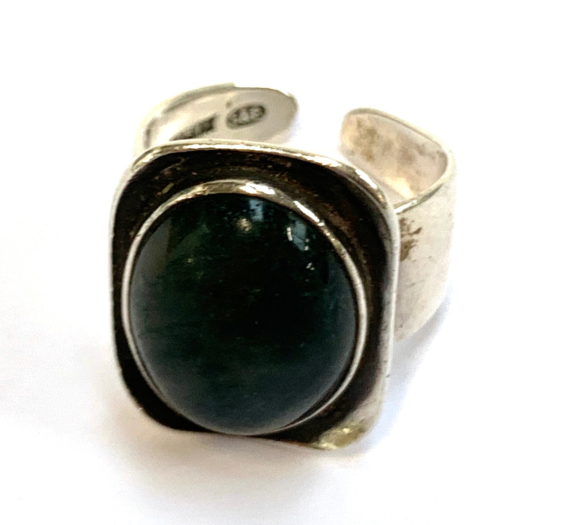 A silver 1970s Modernist ring set with a moss agate cabochon, hallmarked for Smith & Ewen,
