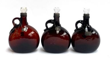 Three brown glass onion decanters, one af, each with silver collar and silver decanter label,
