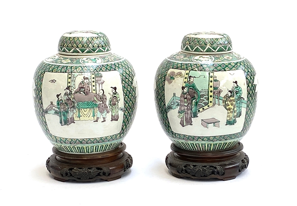 A pair of Chinese famille verte ginger jars depicting court scenes, 23.5cmH, on carved hardwood