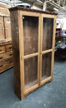 A 19th century glazed pine bookcase (adjustable shelves missing), 106x27x169cm