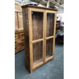 A 19th century glazed pine bookcase (adjustable shelves missing), 106x27x169cm