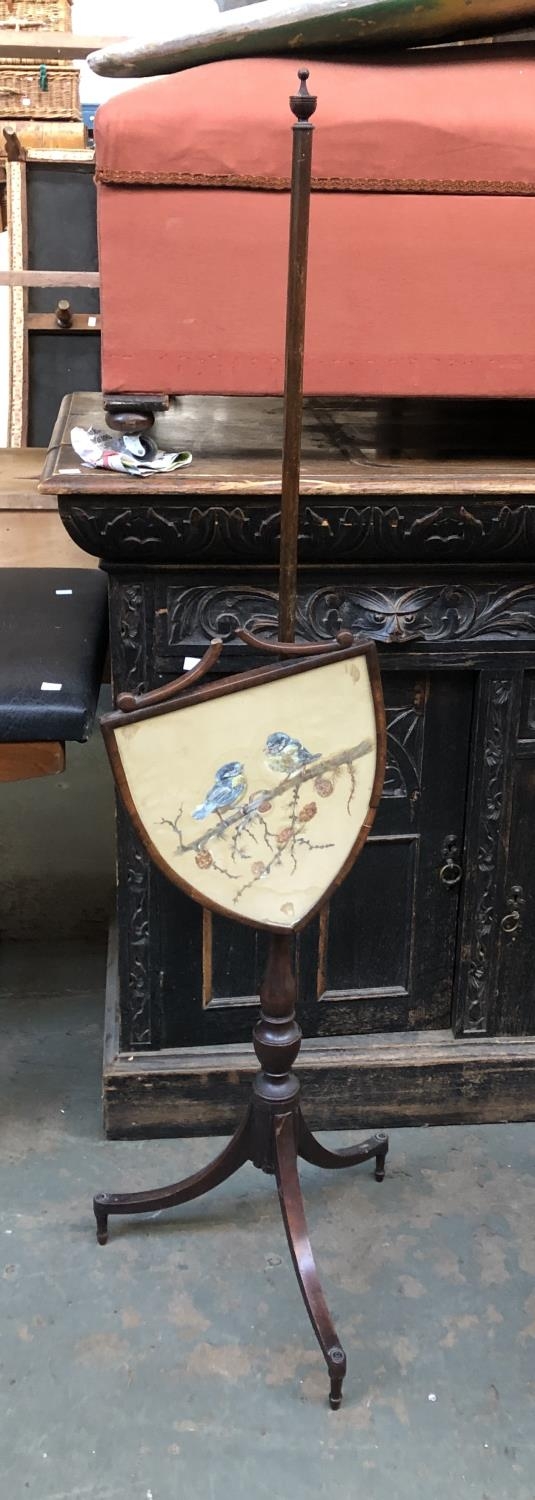 A Regency mahogany pole fire screen (af), the shield shaped screen with a watercolour of a pair of