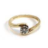 A 9ct gold ring with a crossover set diamond, the diamond 3.8mm diameter, size P 1/2, 2.6g