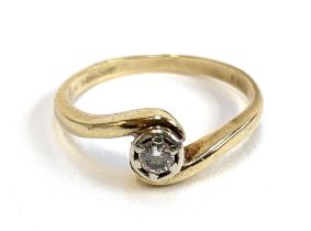 A 9ct gold ring with a crossover set diamond, the diamond 3.8mm diameter, size P 1/2, 2.6g