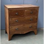 An early 19th century mahogany chest of two short over two long drawers, over a shaped apron, on