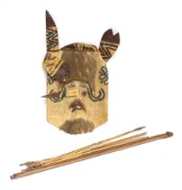 An African ceremonial hide mask, 32cmW; together with bow and arrows