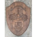 A carved shield plaque bearing the MacDonald crest with the motto per mare per terras, 67x48cm