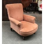 A late 19th century armchair on turned front legs and casters