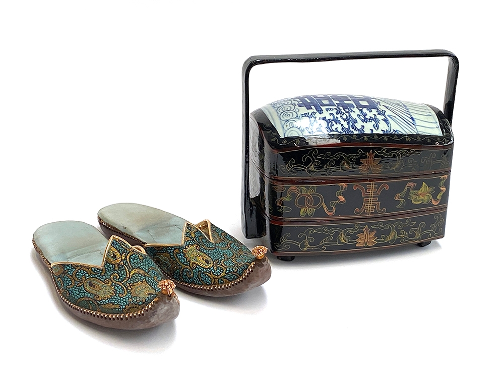 A Chinese lacquered lunchbox with porcelain fragment lid, together with a pair of Eastern slippers
