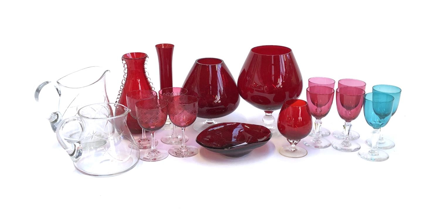 A mixed lot of mainly cranberry glass to include small wine glasses, vases, handblown jug, brandy